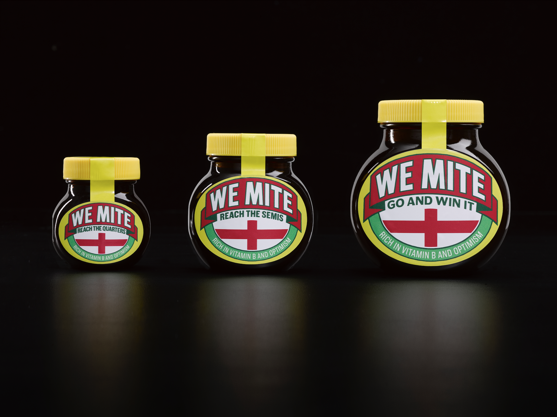 Three Marmite 'We Mite' jars of increasing size, labelled Reach the Quarters, Reach the Semis, and Go and Win It.